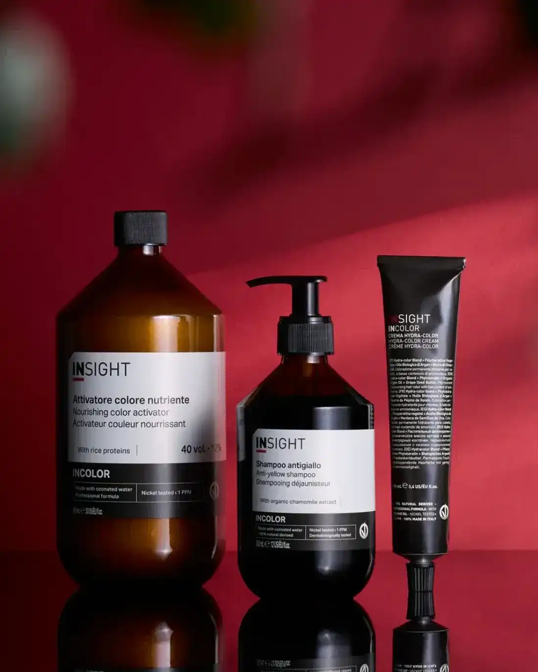 Nourishing hair care products against a red background, including shampoo and color activator.